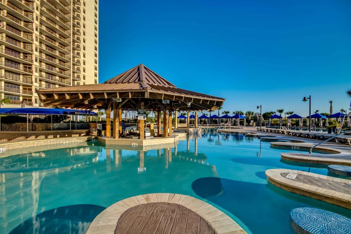 A lively pool area is featured, complete with a shimmering pool, shaded gazebo, and rows of inviting lounge chairs. The space is designed for swimming, sunbathing, and socializing, echoing the family-friendly energy of the resort's pool complex.